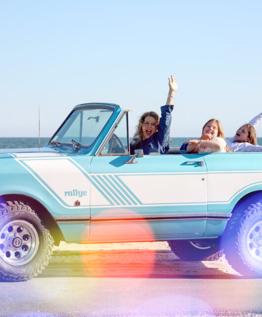 Holly, Dune Jewelry's founder and CEO, and her two daughters in a light blue truck driving in Cape Cod. Mother's Day Jewelry Gift Guide header image.