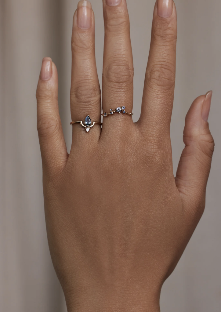 Product shot of hand wearing th Pear Cut Sapphire And Diamond Nestled Ring No. 15 by WWAKE, sustainable jewelry.