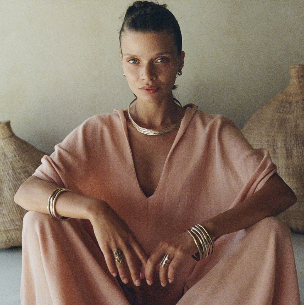Photo of woman wearing the Chantara Collar, Reclaimed Solid Polished Bronze, 925 Sterling Silver, and Gold for Dune Jewelry's sustainable jewelry blog.