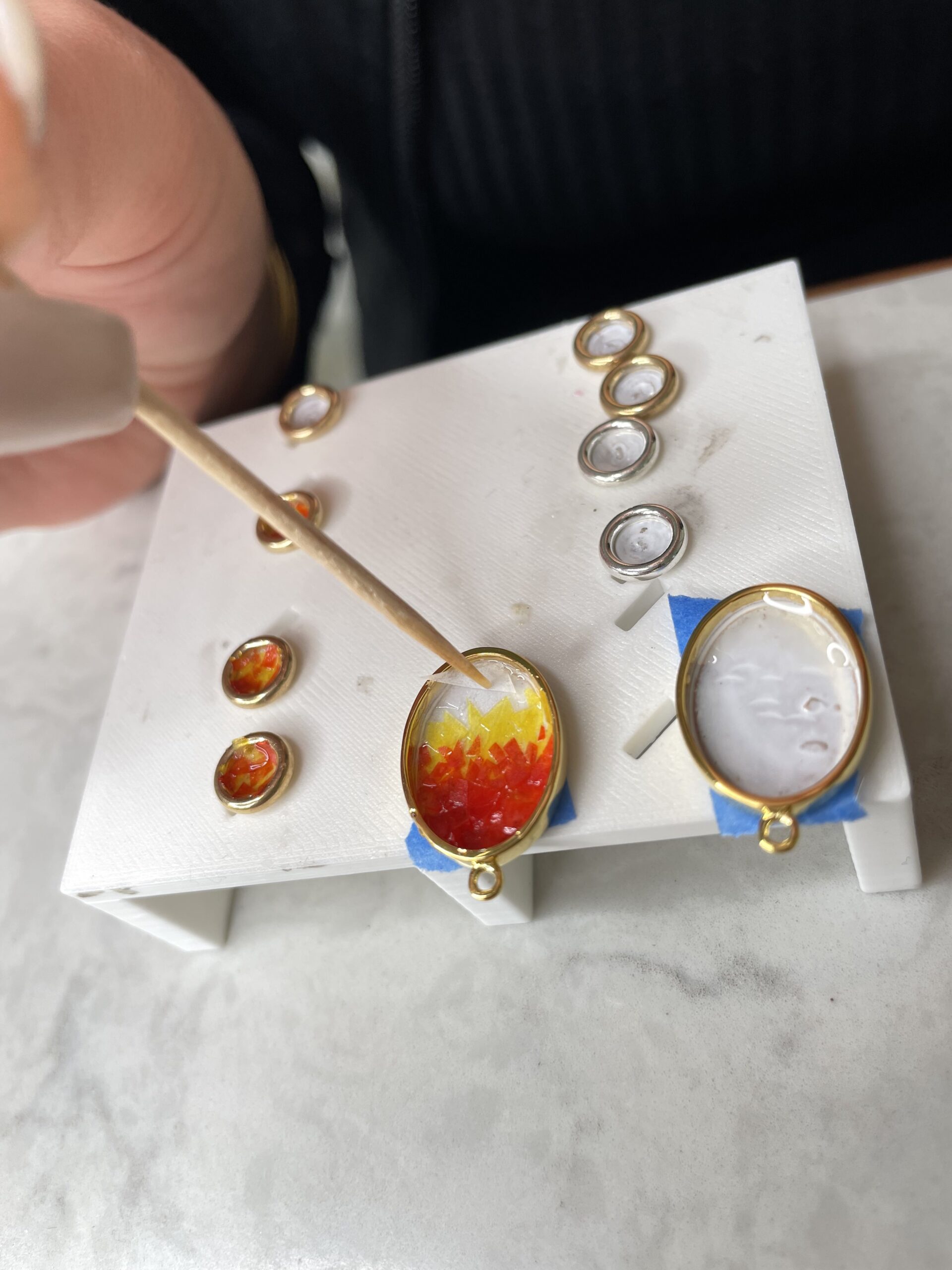 Handcrafting the Super Bowl confetti Sandrop Earrings by Dune Jewelry.