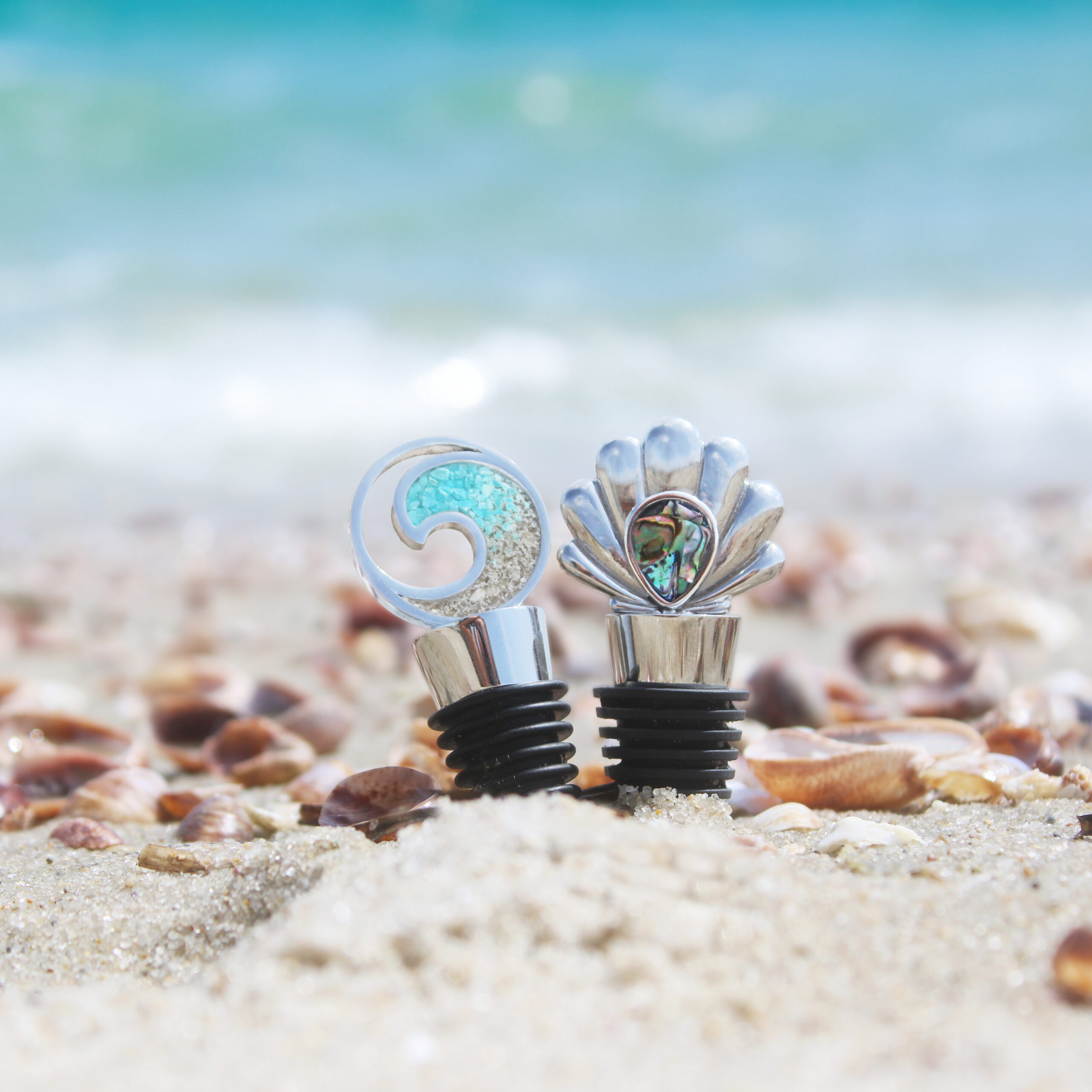 Great housewarming gifts or gifts for mom this summer, the customizable Wave Wine Stopper and Coastal Shell Wine Stopper are handcrafted with beach sand, turquoise, abalone, or elements.