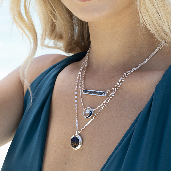 Natural precious gemstone gradients personalized with meaningful sand or earth. Custom Ruby, Emerald and Sapphire gemstone gradient jewelry by Dune Jewelry.