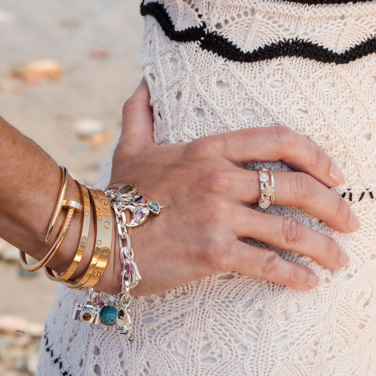 Ocean trio stacker ring by Captain Kate, featuring two flanking moonstone cabochons and a sand or earth element as center stage.
