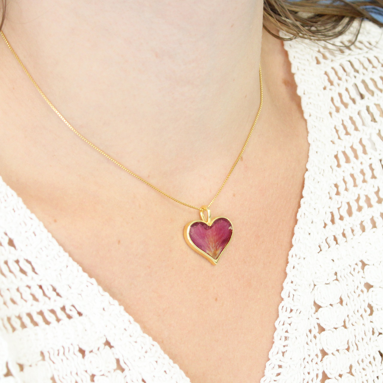 This heartwarming design features a 14k gold coastal jewelry vermeil heart handcrafted with an abalone shell fragment gradient and sand, shells, or earth elements from your favorite location. 