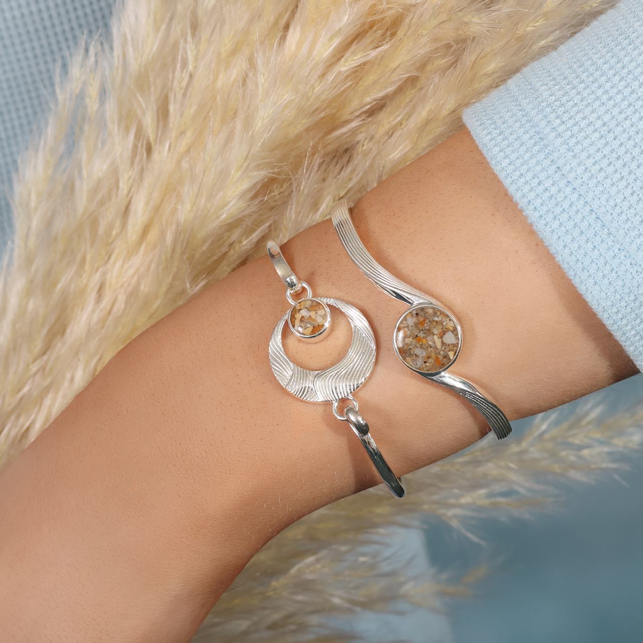 Cuff bracelet handcrafted with sterling silver featuring an ocean wave design and your choice of sand or element. Great jewelry design for ocean aficionados and beach lovers.